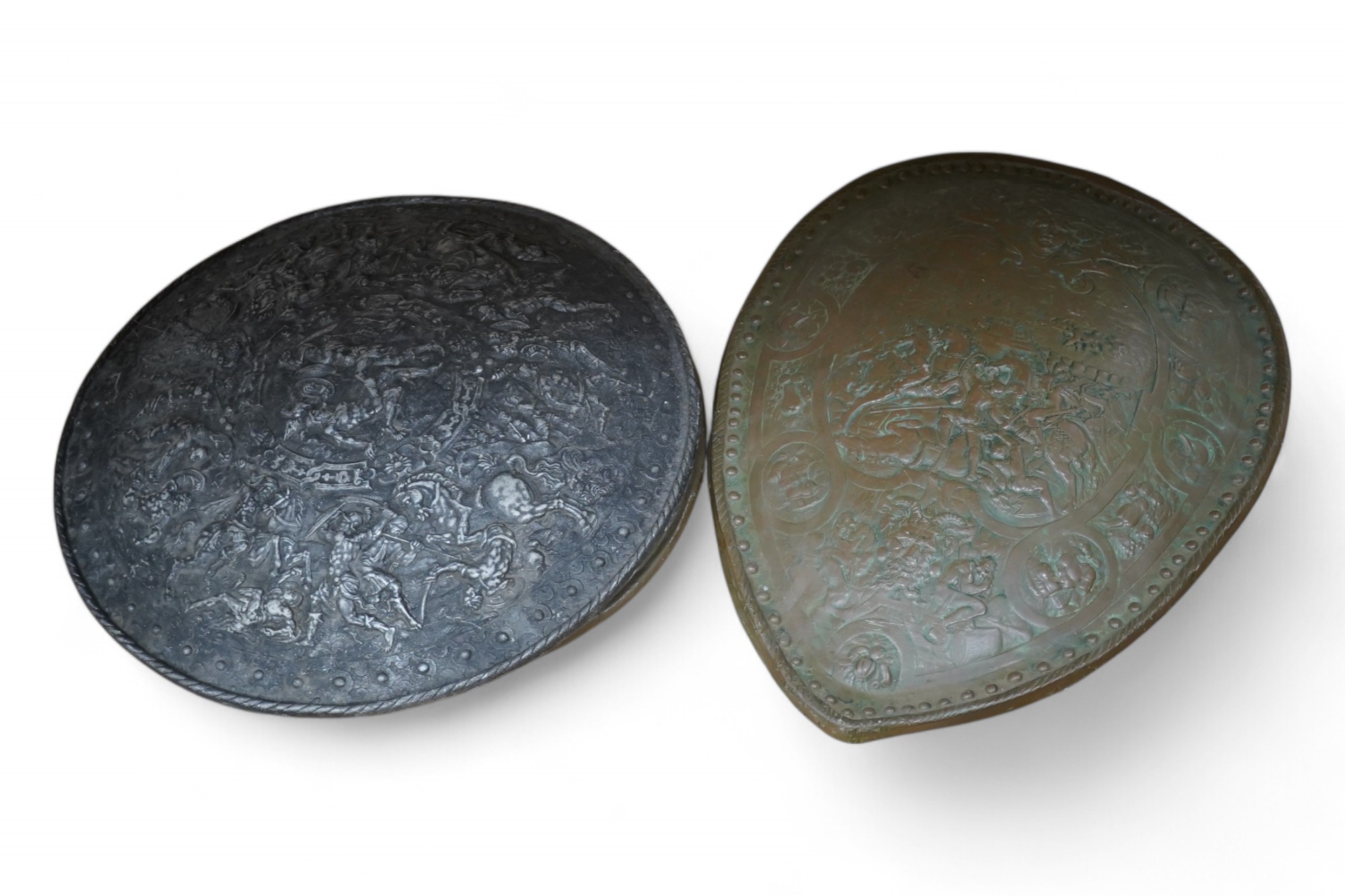 Three metal castings of decorative embossed shields, decorated with battle scenes, ancient armour, etc., diameter of largest 51.5cm. Condition - fair